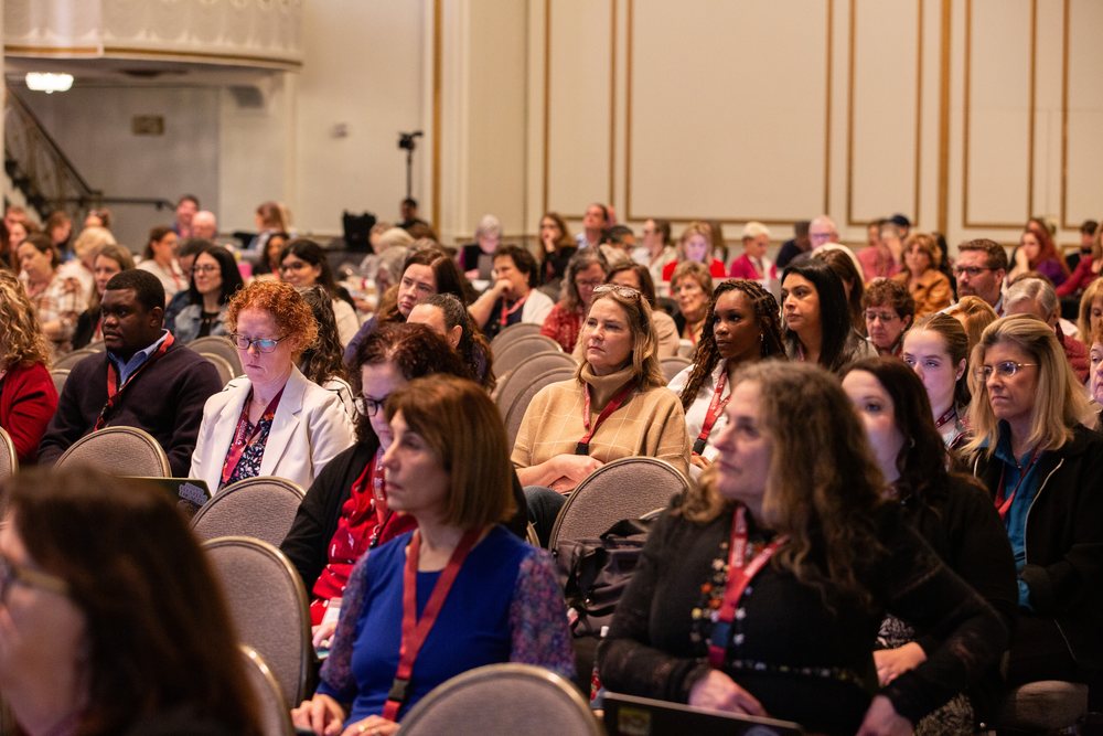Attendees seated closely together during a session